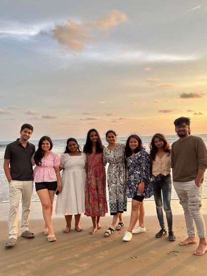A beautiful group photo on the beach at sunset, capturing the calm and scenic end to a day of exploration in Gokarna.