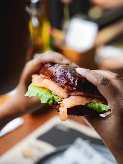 A close-up of our lye-dipped bagel sandwich, showing the glossy crust and fresh fillings.