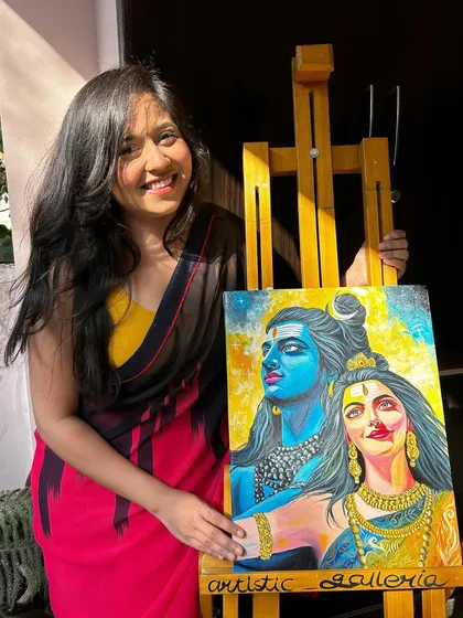 Here I am with the completed Shiv Parvati painting on my easel. I love the vibrant contrast between the cool blues and warm yellows in this piece.