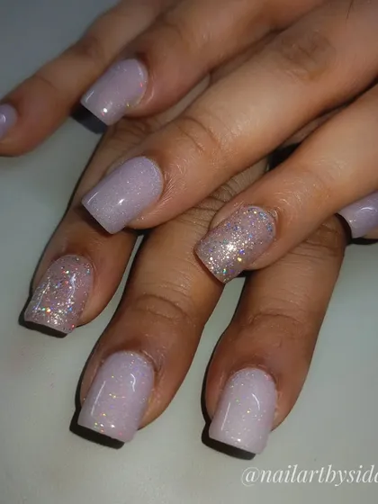 A soft and pretty look using a lavender base with holographic shimmer and a sparkling accent nail.