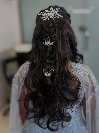 Another view of this princess-like hairstyle, showing the combination of braids, curls, and accessories.