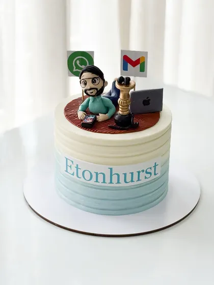 A personalized corporate cake for a work-from-home professional, complete with a fondant figurine, a laptop, and logos of essential apps like Gmail and WhatsApp.