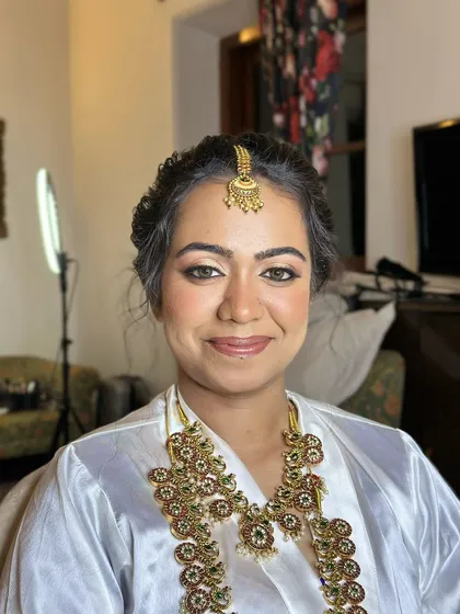 A portrait in her robe, the focus entirely on the beautiful, glowing makeup and traditional jewellery.
