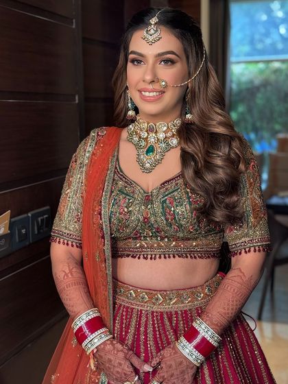 A smiling bride with her hair in soft, romantic waves.