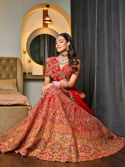The full bridal look, showcasing the magnificent red lehenga and the complementary makeup. A true vision of traditional Indian beauty.