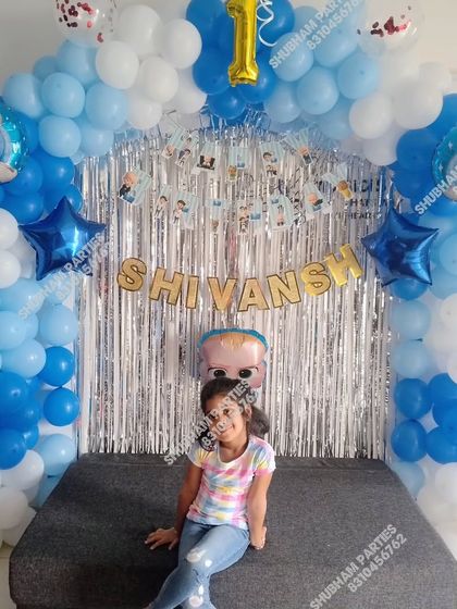 A simple Boss Baby themed setup for a home party, with a silver curtain backdrop.