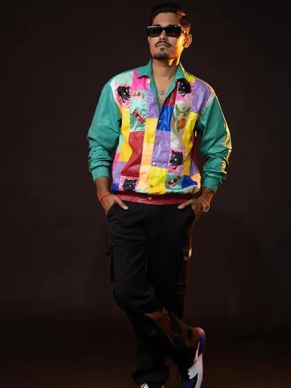 Another pose in the patchwork jacket, showing how it looks when worn with confidence. This is a great example of statement styling for men.