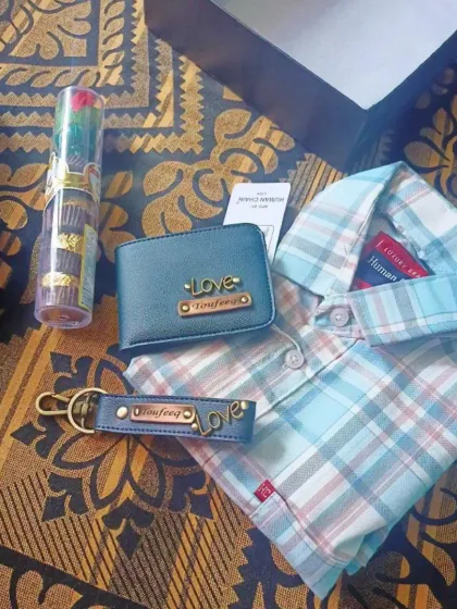A simple yet heartfelt combo gift, this set includes a personalized wallet and a matching keychain, paired with a shirt and a decorative rose.