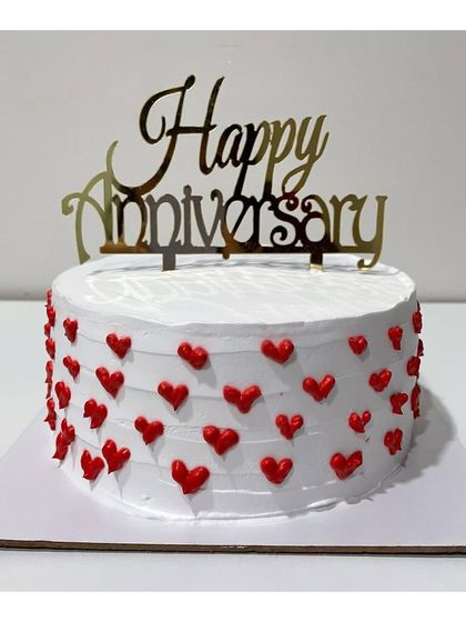 A Ferrero Rocher anniversary cake covered in tiny red hearts. A sweet and simple way to say "I love you.".