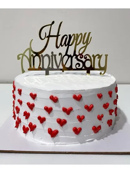 A Ferrero Rocher anniversary cake covered in tiny red hearts. A sweet and simple way to say "I love you.".