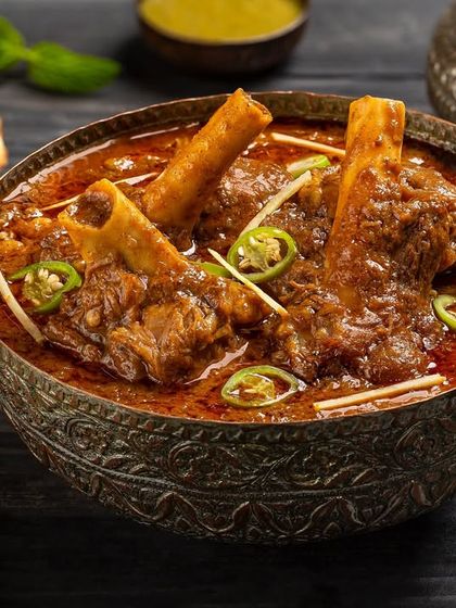 A hearty mutton nihari with bone-in pieces, garnished with ginger and green chillies for Nazeer Foods.