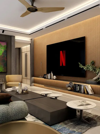 A media room in Walkeshwar that offers a meditative quality, making home a true retreat. A large screen is set against a textured wood-paneled wall, with a comfortable, modern sofa and curated art pieces completing the strikingly minimal aesthetic.