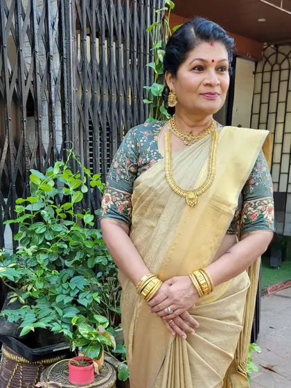 My teacher in another stunning look, this time a golden tissue saree paired with a floral blouse. Her elegance is timeless.