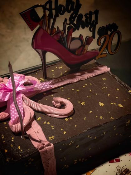 A fun and stylish cake for a 20th birthday celebration. This dark chocolate cake features a playful high-heel topper and a beautifully crafted pink bow, showing how I can match the cake to any party's theme.