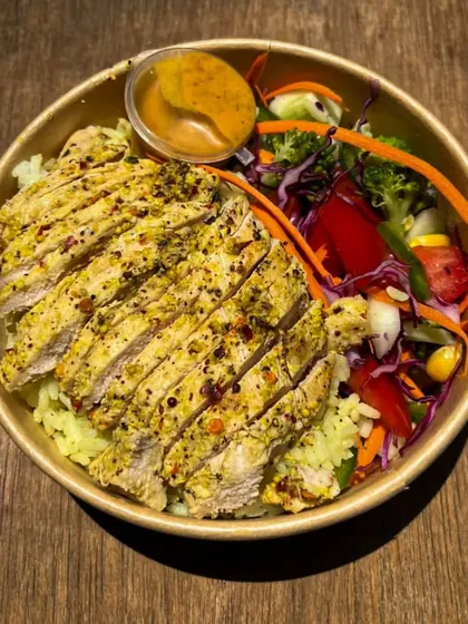 This is my popular Grilled Chicken Meal. It features perfectly seasoned, sliced grilled chicken served over turmeric rice with a side of fresh, crunchy salad. It's a balanced and satisfying high-protein option.