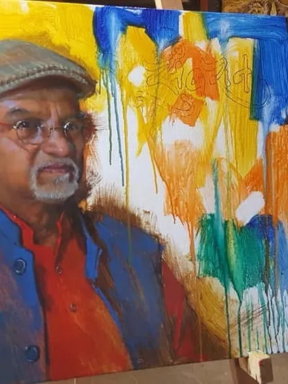 The portrait of Raosaheb Gurav Sir in progress, with an abstract and colorful background taking shape.