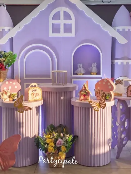 This fairy garden party featured a beautiful lavender castle backdrop, surrounded by butterfly details and mushroom props. The light-up number '3' and custom-designed plinths for desserts completed this magical setup for Amayra's third birthday.