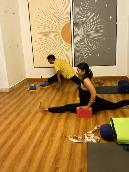 Using blocks for support in Hanumanasana (the splits) helps to stabilize the pose and keep the hips and shoulders square. This allows for a gradual and safe opening.