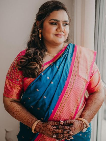 A candid moment of the bride, looking radiant. The dark stain of her full bridal mehendi is a key part of her stunning look.