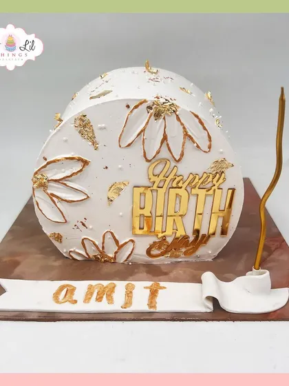 A modern and artistic arch-shaped cake for Amit's birthday, featuring a gold-outlined floral pattern and gold leaf accents.