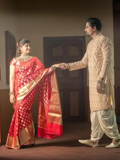 A cinematic pre-wedding shot of a couple in a traditional wada, capturing a classic, romantic mood.