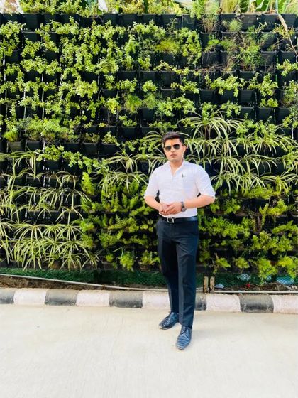 A moment of pause against a green wall. I keep my feet on the ground but my eyes are always aimed at achieving the highest goals.