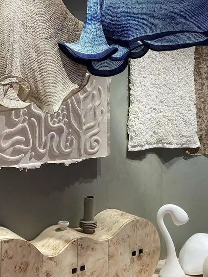 A collection of objects inspired by our 'Shroom' theme. The display features swan-like sculptures, a cabinet with an organic form, and hanging textile pieces that mimic the textures of fungi.