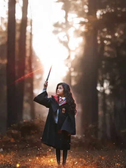 "Lumos!" A powerful portrait of a young witch casting a light spell in a misty, magical forest. The lighting and effects make this shot truly special.