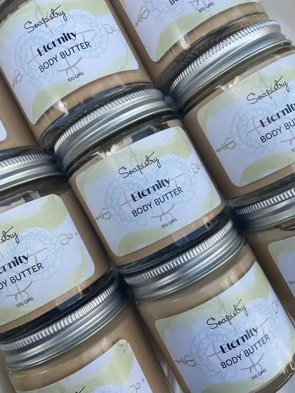 My product line goes beyond just soaps. This is my Eternity Body Butter, made with nourishing ingredients like Seabuckthorn oil, which I discovered on my travels. It's designed to boost collagen, reduce dryness, and give your skin an incredible glow.