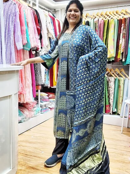 Another view of our customer wearing her custom-stitched kurti inside the boutique. The beautiful blue Ajrakh print looks stunning on her.