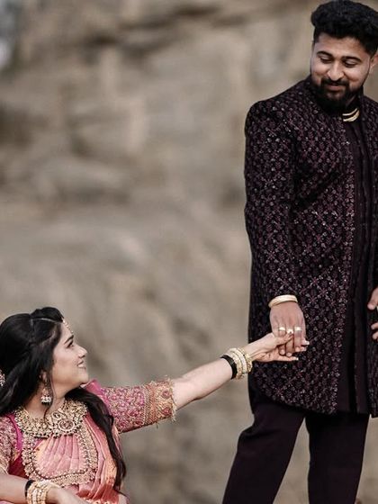 A playful take from the rocky landscape shoot, with the bride reaching for the groom's hand. It adds a touch of storytelling to the portrait.
