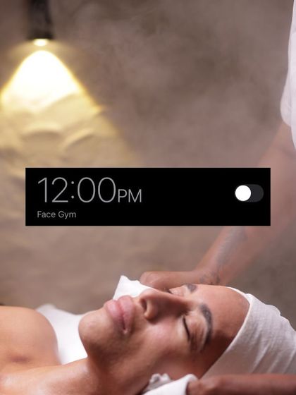 It's 12:00 PM, time for your Face Gym appointment. This image captures a client enjoying a moment of pure relaxation while our therapist works to tone and sculpt her skin.