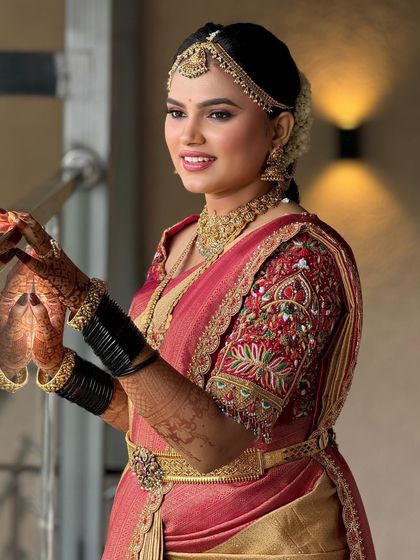 A candid shot of the bride, capturing her natural smile and the way the makeup enhances her joyful expression.