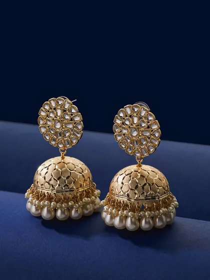 Capturing traditional Jhumkas is a challenge I wanted to get just right. For these gold and pearl earrings, I used a deep blue background to make the gold pop. The lighting is soft but precise, highlighting the intricate metalwork and the luster of the pearls.