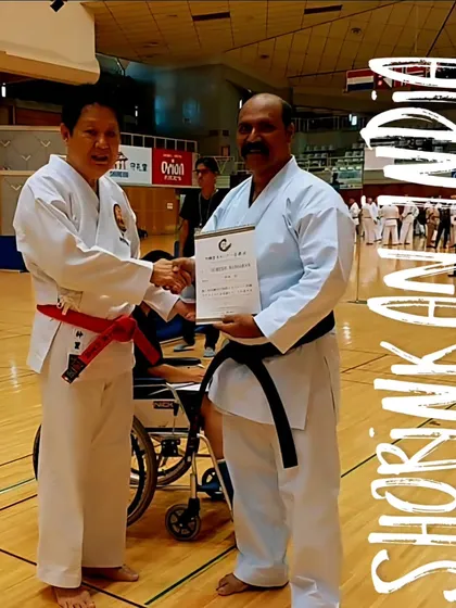 Receiving a certificate from Hanshi Minoru Nakazato, the world chairman of Shorinkan, in Okinawa. This represents our official connection and recognition from the highest authority.