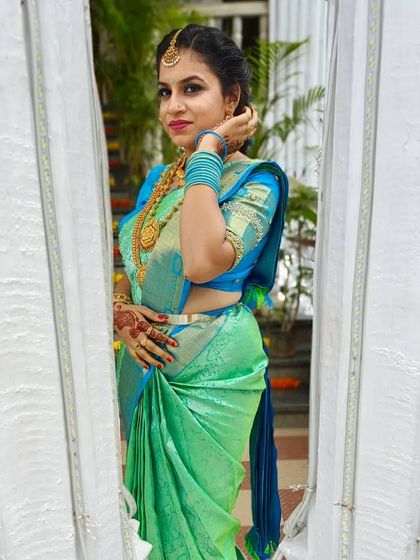 A playful and beautiful shot of Kavya. Her makeup is fresh, and the colors of her outfit are vibrant.