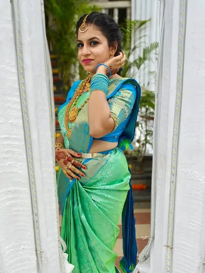 A beautiful candid-style photo of Kavya, showing the side profile and the detailed hairstyle.