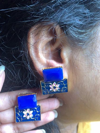 A modern take on Meenakari, these two-tiered studs feature a royal blue stone and a hand-painted floral base. They are chic, stylish, and unique.