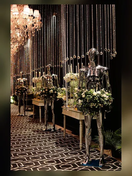 An artful installation of chrome mannequins holding bouquets, lining the entrance to a cocktail party. This is an example of my unconventional and creative design approach.