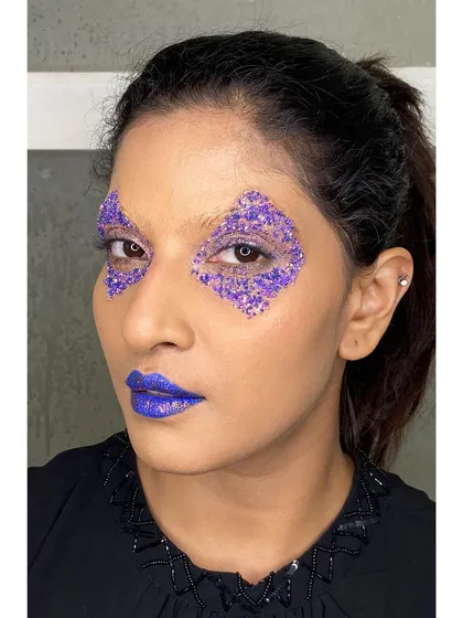Creating sharp, geometric shapes with glitter is one of my favorite techniques for an edgy editorial concept. Here, I used purple glitter to craft a diamond shape around the eye, paired with a bold purple lip.