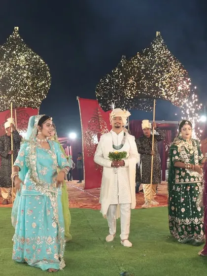 A royal groom's entry. He was welcomed by dancers and cold pyro fireworks, setting a majestic tone for the wedding ceremony that followed.