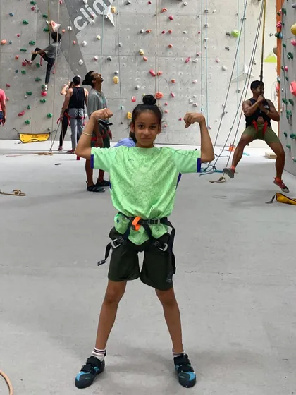 Feeling strong after a great climb! We encourage kids to celebrate their achievements, big or small.