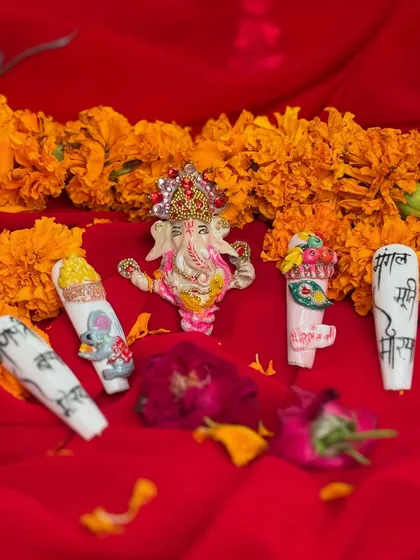 Themed nail art for Ganesh Chaturthi, featuring intricate hand-painted designs of Lord Ganesha, a mouse, and auspicious symbols.
