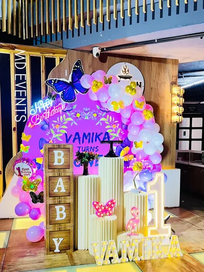 A different angle of the purple butterfly first birthday party, showing how the balloon colors and props come together to create a cohesive and magical theme.