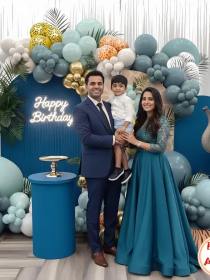 A chic and modern take on a jungle safari theme. This setup uses a sophisticated color palette of blues and greens, with animal print balloons, tropical leaves, and a neon 'Happy Birthday' sign for a stylish celebration.