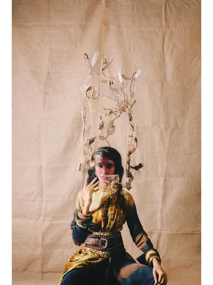 A surreal and artistic look from 'Neo-Boheme'. The styling includes a unique, branch-like headpiece, pushing the boundaries of conventional fashion.