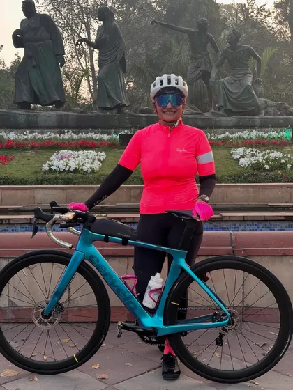 A rider posing with her beautiful turquoise Factor bike.
