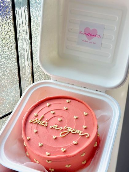 A coral-colored bento cake for a Gemini, calling her a gem. The tiny gold hearts add a little bit of sparkle to this zodiac-themed cake.