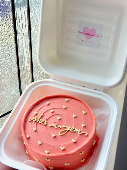 A coral-colored bento cake for a Gemini, calling her a gem. The tiny gold hearts add a little bit of sparkle to this zodiac-themed cake.