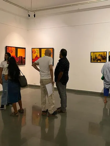 A group of visitors, including the artist, discussing the works during the final week of the exhibition.